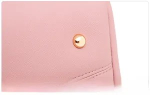 Detail of pink Saffiano leather strap with precision stitching and gold rivet reinforcement