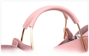Detail of pink Saffiano faux leather handbag with light gold metal ring handle texture