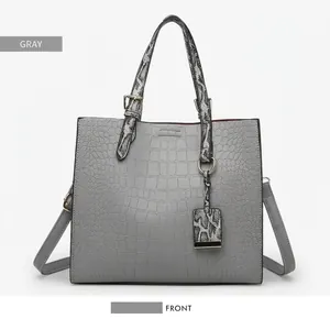 Front view of grey faux leather tote with crocodile texture and snake skin patterned handles
