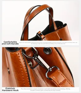 Detailed view of caramel brown pebbled leather texture with gunmetal hardware hooks