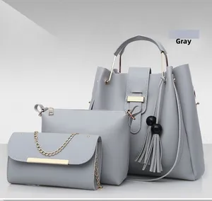 Detailed view of gray 3-piece bag set with tote, pouch, and chain crossbody bag