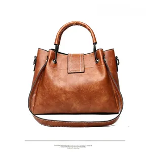 Back view of brown vintage bucket bag with contrast stitching and metal handle