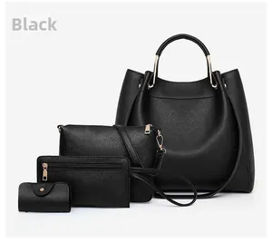 Detail of 4-piece black tote bag set featuring textured faux leather and gold hardware