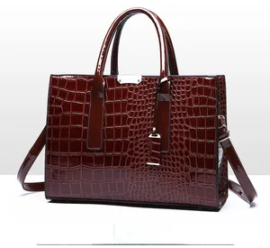 Detail view of burgundy croc-embossed tote bag from a 45-degree side angle
