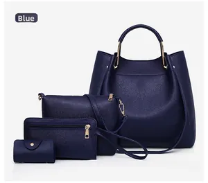 Detail of blue four-piece women's handbag set including tote and crossbody bag