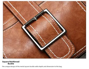 Detail of square dark gray metal buckle and stitching on brown leather bucket bag