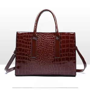 Detailed back view of dark brown faux leather tote with embossed crocodile pattern texture