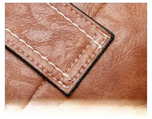 Close-up of precise beige stitching and natural grain texture on the brown leather bucket bag