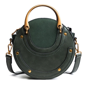 Retro dark green circular crossbody bag with frosted leather and golden metal handle