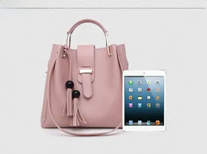 Size comparison view of pink PU leather handbag and shoulder bag next to a tablet
