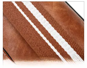 Close-up of brown leather bucket bag featuring a white and brown woven strap detail