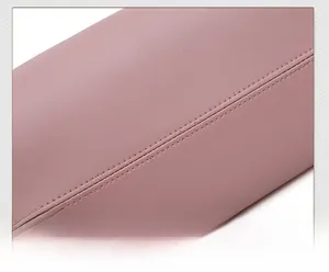 Detail of rose pink leather handbag featuring reinforced double-stitched seams and texture