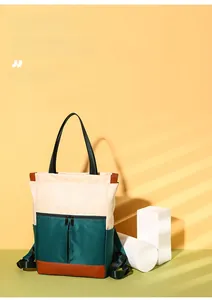Detailed view of color-block nylon backpack with geometric accents on a modern pedestal