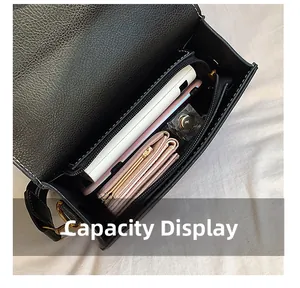 Internal view of black leather handbag showing spacious capacity and zipper pocket