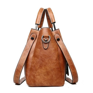 Vintage brown oil wax leather bucket bag with metal handles and shoulder strap