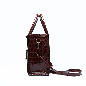 Fashionable crocodile pattern tote bag in dark brown with handles and shoulder strap