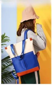 Three-color nylon crossbody bag shown on a model with blue straps and zippers