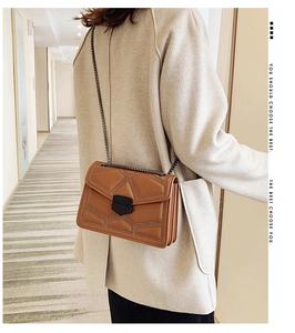 Caramel quilted chain bag with rivet trim shown on a model in a minimal setting