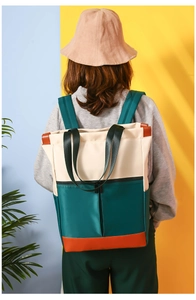 Model wearing a multi-color nylon backpack in beige, dark green, and orange brown