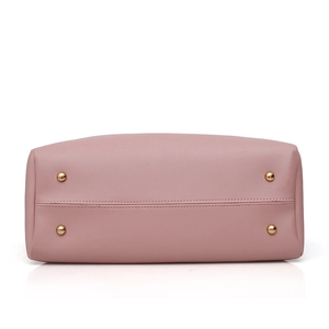 Pink faux leather handbag base showing four gold protective feet and reinforced stitching