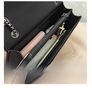Internal view of the black leather bag showing multi-layer storage and capacity