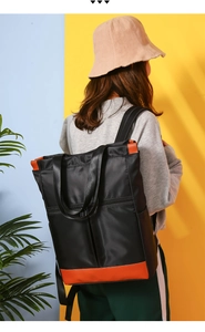 Outdoor waterproof nylon backpack with orange leather trim details shown on model