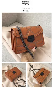 Detail view of brown leather crossbody bag with dark metal rivets and chain strap