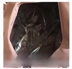 Internal view of a pink sports bag showing waterproof PVC dry-wet separation pocket