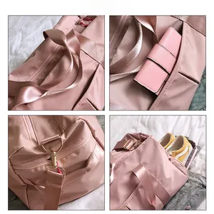 Pink fitness bag detail showing separate shoe compartment and metal buckle hooks