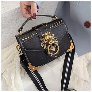 Detail of vintage black PU crossbody bag with lion head hardware and gold studs
