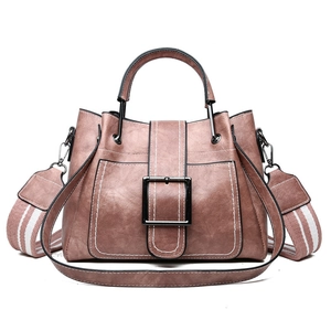 Vintage pink faux leather bucket bag with metal handle and striped wide shoulder strap