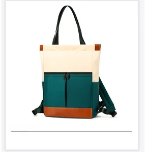 Detailed view of the color-block nylon backpack showing carrying handles and side pockets