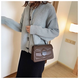 Brown leather crossbody bag with rivet geometric patterns and metallic chain strap