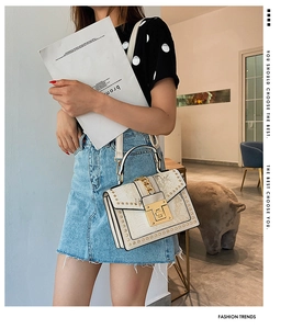 Chic beige snakeskin embossed shoulder bag with gold rivets and metallic lock detail