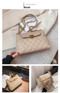 Detail showing khaki quilted chain bag with elegant metal square lock and leather strap