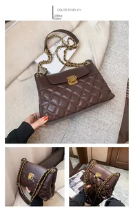 Detail of coffee brown quilted crossbody bag featuring golden chain strap and twist lock