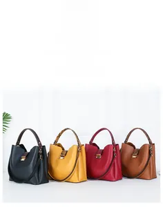 Collection of faux leather bucket bags in black, yellow, red, and brown with snake detail