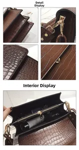 Détails d'un sac à bandoulière marron motif crocodile avec boucles dorées et intérieur