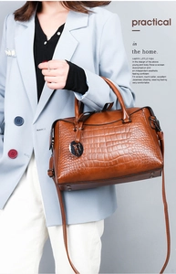 Brown crocodile pattern leather tote bag with F-pendant shown on a fashion model
