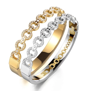 Detailed macro view of gold and silver interlocking bangles with pave-set zircons