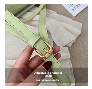 Detail of adjustable mint green shoulder strap with gold buckle and lychee texture