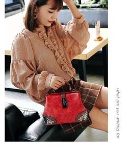 Retro red doctor bag featuring vintage rivets, dark top handle and metal lock detail