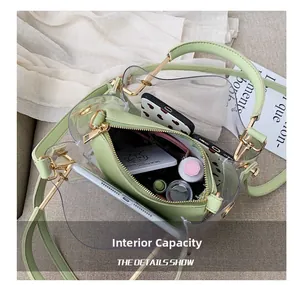 Light green transparent PVC crossbody bag showing internal storage capacity with essentials