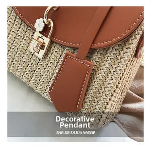 Macro shot of handwoven straw bag featuring brown leather flap and golden metal twist lock