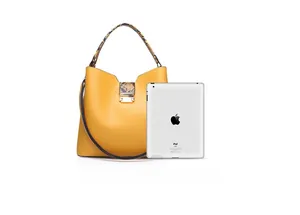 Yellow tote bag size comparison with an iPad showing its medium capacity and snake print handle