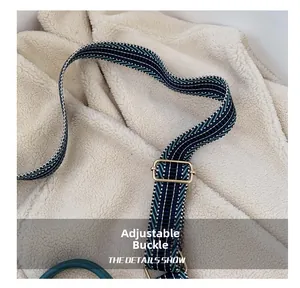 Detail of colorful woven shoulder strap with adjustable golden metal buckle and hardware