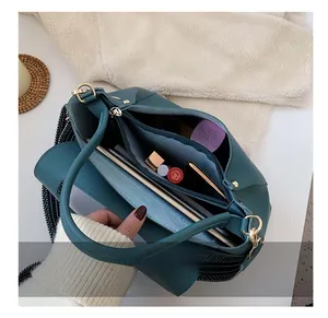 Internal layout of green leather handbag with zipper compartments and storage capacity