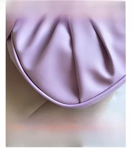 Close-up of lavender pleated faux leather cloud bag showing fine stitching and texture