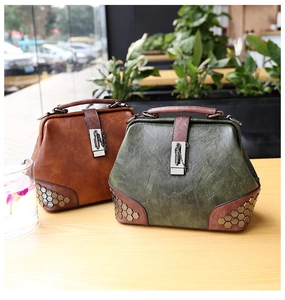 Detail showing vintage rivet texture and metal lock on retro doctor style handbag