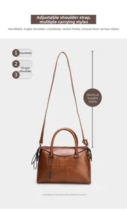 Detail of brown crocodile pattern leather handbag showing 54cm height and shoulder strap